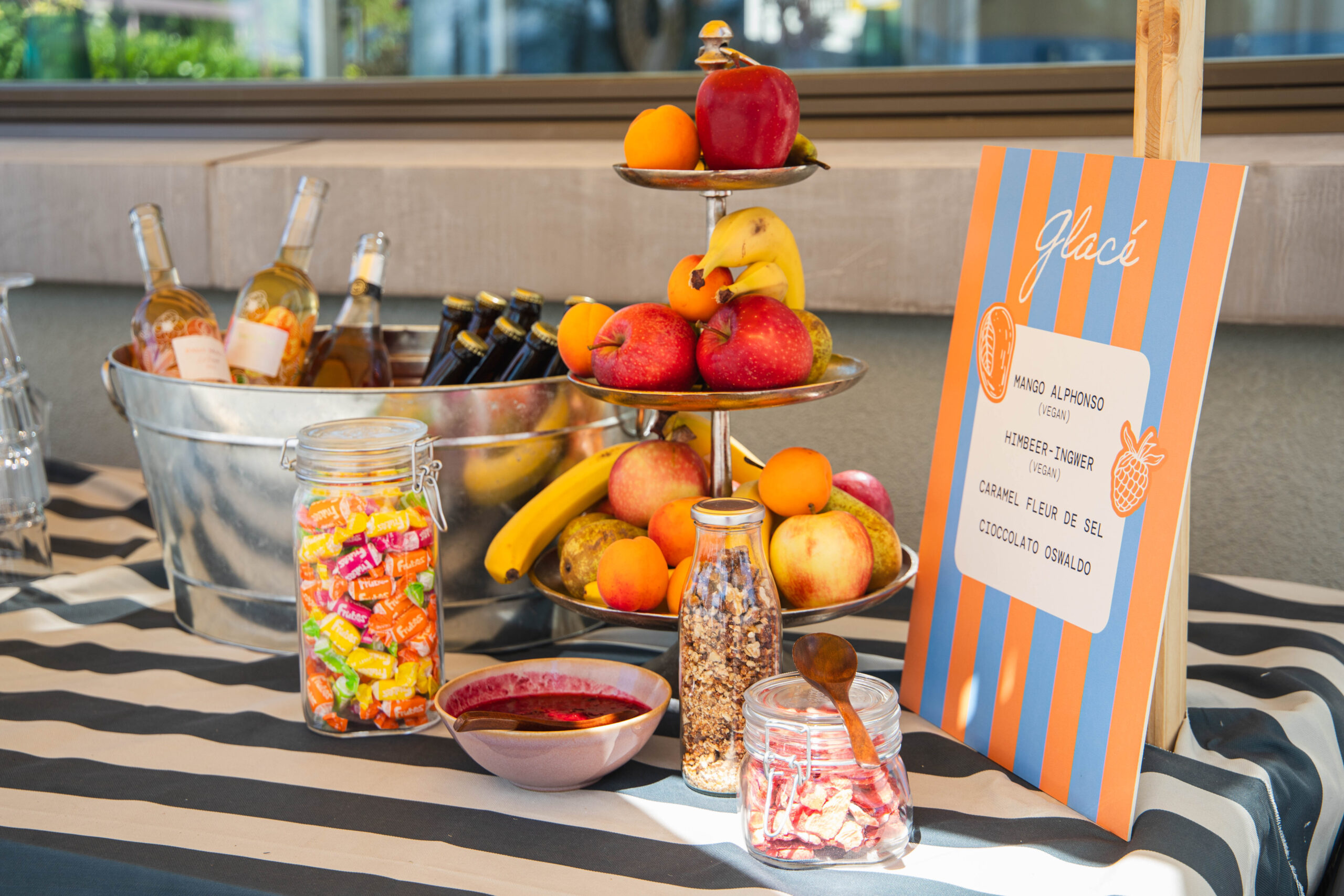 Spiegelung eines Buffets mit Früchten und veganen Dessertschildern